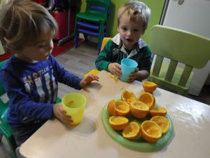 The image shows a child sat at a table in the nursery to prove the skills that they are learning by attending the nursery.